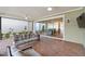 Screened-in patio features brick flooring, comfortable seating, ceiling fans, and sliding glass doors at 1801 Coastal Ct, Celebration, FL 34747