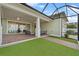 Covered outdoor patio has brick floors, artificial turf, ceiling fans, and comfortable seating at 1801 Coastal Ct, Celebration, FL 34747