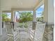 Relaxing front porch features rocking chairs, charming details and a welcoming atmosphere at 1801 Coastal Ct, Celebration, FL 34747
