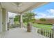 Inviting covered porch with stone accents, ceiling fan, and views of the lush green landscape at 1801 Coastal Ct, Celebration, FL 34747