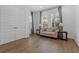 Bright sitting room with hardwood floors, large windows, shutters, and elegant furnishings at 1801 Coastal Ct, Celebration, FL 34747