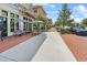 Street view of retail storefronts with outdoor seating, umbrellas, and pedestrian walkway at 1801 Coastal Ct, Celebration, FL 34747