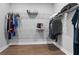 Bright walk-in closet with custom shelving for organized storage, plus hardwood floors at 1801 Coastal Ct, Celebration, FL 34747
