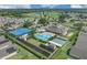 Stunning aerial view of community center with pool, tennis, and recreation areas near lush golf course at 231 Lewis Dr, Davenport, FL 33837