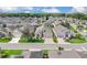 Aerial view of a well-maintained neighborhood showcasing beautiful homes and lush green landscaping, great for families at 231 Lewis Dr, Davenport, FL 33837