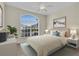 Inviting bedroom featuring a plush queen bed, modern decor, and a large window with natural light at 231 Lewis Dr, Davenport, FL 33837