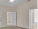Bedroom with neutral walls, carpet flooring, and an ensuite bathroom at 231 Lewis Dr, Davenport, FL 33837