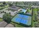 Aerial view showcasing community amenities like tennis courts, a pool, and a clubhouse in a beautiful neighborhood at 231 Lewis Dr, Davenport, FL 33837