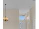 Warm and inviting foyer featuring high ceilings, chandelier, white front door with sidelights, and arched openings at 231 Lewis Dr, Davenport, FL 33837
