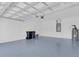 Garage features a blue epoxy floor at 231 Lewis Dr, Davenport, FL 33837