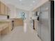 Well-lit kitchen features light wood cabinets, stainless steel appliances, tile flooring and a large window at 231 Lewis Dr, Davenport, FL 33837
