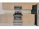 The kitchen features stainless steel appliances and wood cabinets at 231 Lewis Dr, Davenport, FL 33837