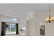 Bright living room featuring dining area, modern furniture, chandelier, and sliding glass doors to backyard at 231 Lewis Dr, Davenport, FL 33837