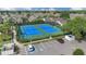 Well-maintained blue tennis courts with parking spots surrounded by lush landscaping in a lovely community at 231 Lewis Dr, Davenport, FL 33837