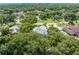Aerial view of the neighborhood shows lush trees and landscaping with many other homes nearby in a desirable area at 2376 Nightingale Ln, Kissimmee, FL 34746