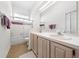 Bright bathroom with dual sinks, tub, and a separate door for convenience at 2376 Nightingale Ln, Kissimmee, FL 34746