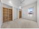 Spacious bedroom with built-in shelves, ceiling fan and neutral carpeting at 2376 Nightingale Ln, Kissimmee, FL 34746