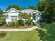 Inviting single-story home featuring a well-manicured lawn, lush landscaping, and a charming entrance at 2376 Nightingale Ln, Kissimmee, FL 34746