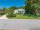 Charming single-story home featuring mature trees, lush landscaping, and a well-maintained lawn at 2376 Nightingale Ln, Kissimmee, FL 34746