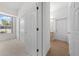 Hallway view with storage closets, window, and door to bath at 2376 Nightingale Ln, Kissimmee, FL 34746