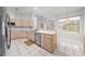 Spacious kitchen features stainless steel appliances and large windows with backyard views at 2376 Nightingale Ln, Kissimmee, FL 34746
