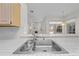 Close-up of kitchen sink with a view into an open floor plan at 2376 Nightingale Ln, Kissimmee, FL 34746