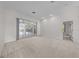 Bright and spacious living room with neutral carpet and sliding glass door to the backyard at 2376 Nightingale Ln, Kissimmee, FL 34746