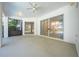 Large screened-in patio area with plenty of room for seating and sliding glass doors at 2376 Nightingale Ln, Kissimmee, FL 34746