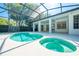 A screened-in pool with a jacuzzi and patio offer an outdoor getaway in this home at 2376 Nightingale Ln, Kissimmee, FL 34746