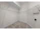 Walk-in closet with wire shelving and neutral carpet at 2376 Nightingale Ln, Kissimmee, FL 34746