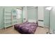 Cozy bedroom featuring wood flooring, built-in shelving, murphy bed and ample light at 2416 White Poppy Dr, Kissimmee, FL 34747