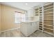 Bright room features built in cabinets and shelves, and a center island, creating a practical walk-in closet at 2416 White Poppy Dr, Kissimmee, FL 34747