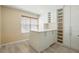 Bright room features built in cabinets and shelves, and a center island, creating a practical walk-in closet at 2416 White Poppy Dr, Kissimmee, FL 34747