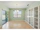 Bright dining room featuring tile flooring, glass sliding door, and built-in white display shelving at 2416 White Poppy Dr, Kissimmee, FL 34747
