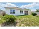 Home's exterior showcasing the well-maintained backyard, and screened patio at 2416 White Poppy Dr, Kissimmee, FL 34747