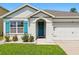 Close up of the exterior with turquoise shutters and an arched entryway at 2416 White Poppy Dr, Kissimmee, FL 34747