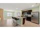 Modern kitchen with granite countertops, stainless steel appliances, and a large island at 2416 White Poppy Dr, Kissimmee, FL 34747