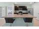 Contemporary kitchen showcasing a large granite island with seating and stainless appliances at 2416 White Poppy Dr, Kissimmee, FL 34747