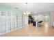 Open-concept living space featuring tile flooring, white shelving, and an eat-in kitchen island at 2416 White Poppy Dr, Kissimmee, FL 34747