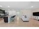 Bright living space featuring tile flooring, kitchen island, white couch and entertainment center at 2416 White Poppy Dr, Kissimmee, FL 34747