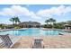 Community pool and splashpad area with lounge chairs for residents to relax at 2416 White Poppy Dr, Kissimmee, FL 34747