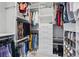 Custom walk-in closet boasts ample hanging space, shelving, drawers, and storage for shoes and accessories at 2416 White Poppy Dr, Kissimmee, FL 34747