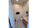 Well-lit half bathroom with tiled floor, modern vanity and toilet at 3014 Red Ginger Rd, Kissimmee, FL 34747