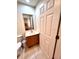 Tiled half-bath with a white single sink vanity, toilet, and large mirror at 3014 Red Ginger Rd, Kissimmee, FL 34747