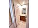 Well-lit half bathroom with modern vanity, mirror, and white paneled door at 3014 Red Ginger Rd, Kissimmee, FL 34747