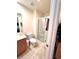 Cozy bathroom featuring a walk-in shower with glass doors, toilet, and vanity with countertop at 3014 Red Ginger Rd, Kissimmee, FL 34747