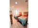 Bright bedroom with two twin beds, colorful bedding and light wood flooring at 3014 Red Ginger Rd, Kissimmee, FL 34747