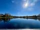Scenic lake view with clear reflections and a tranquil atmosphere, highlighting the beauty of the surroundings at 3014 Red Ginger Rd, Kissimmee, FL 34747