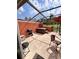 Relaxing screened-in patio area featuring a grill and a hot tub for outdoor enjoyment at 3014 Red Ginger Rd, Kissimmee, FL 34747