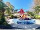 Community playground featuring colorful play structures and a safe, cushioned surface for to enjoy at 3014 Red Ginger Rd, Kissimmee, FL 34747